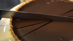 Knife cutting chocolate tart,close up Stock Footage