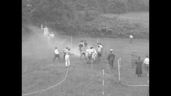 Firemen compete in game fighting for ball with water sprayed from fire hoses News Clip
