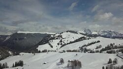 Flying on Seiser Alm with snowcapped mountains in background Stock Footage