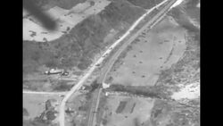 Jets parked, taxiing, and taking off from airfield; aerial views of jets strafing targets during Korean War News Clip