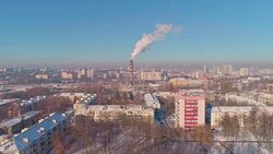 Bad ecology. The thermal power plant located in the center of the residential district, throws out smoke from the high pipe, polluting the atmosphere of the city. Aerial drone video. Stock Footage