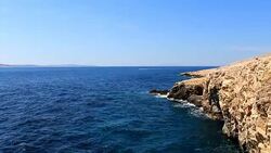 Boat float on sea with cliff Stock Footage