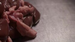 Sequence showing a selection of raw offal on a steel surface in a commercial kitchen, UK. Stock Footage