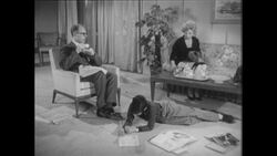 1960s: Boy lays on floor, writes on paper Stock Footage