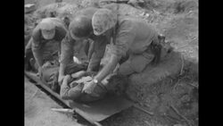 During Korean War, US Marines transport wounded Marines by helicopter during fighting with Communist forces in South Korea News Clip