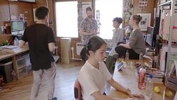 Creative business people talking and eating watermelon in open plan office Stock Footage