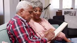 Senior couple meeting with financial advisor and designing documents at home - shot in slow motion Stock Footage
