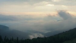 Timelapse. Low clouds covering hillsides of Carpathians mountains, west Ukraine. Extreme long shot. Clouds floating between hillsides covered with green forest. Nature landscape. Blurred background Stock Footage