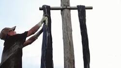 4k footage scene of Vietnamese workers dyeing silk when sunrise in tan chau village, An giang, Vietnam, latest village of ancient culture to dyed, Tradition and Conserve culture concept Stock Footage