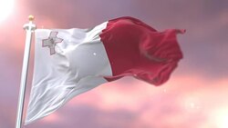 Flag of Malta waving at wind at sunset in slow, loop Stock Footage