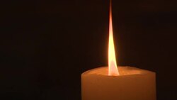 Lit up candle in Westminster Abbey News Clip