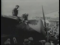 Amelia Earhart, posing with plane, speaking to camera after first female solo flight across Atlantic, disappearance in 1937 Stock Footage