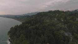 Black Sea in Batumi at dusk, gloomy sky above green botanical garden, travel Stock Footage