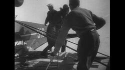 Switzerland, c.1951: After a plane crash in the mountains, two men are helped by guides Stock Footage