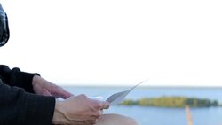A tourist looks at a map in a mountainous area Stock Footage