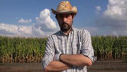 Portrait of serious farmer thinking in corn field Stock Footage