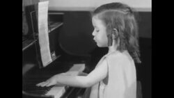 Young girl plays piano and sings to her puppies News Clip