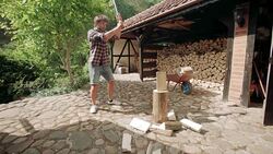 Man splitting logs for firewood Stock Footage