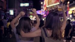 Slow motion - Traveler backpacker Asian women lesbian lgbt couple dancing together. Female drinking alcohol or beer with friends and having party at The Khao San Road in Bangkok, Thailand. Stock Footage