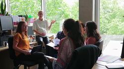 Pregnant Worker Talking about Biology With Colleagues Stock Footage