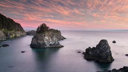 Pink Sunset Sky Above the Sea Stack Islands on the Oregon Coast Stock Footage