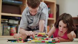 Two kids playing with lego bricks at home Stock Footage