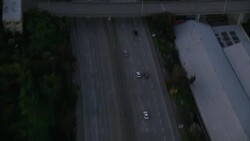 AERIAL BIRDSEYE POV OF CARS DRIVING ON SAN FRANCISCO INTERSTATE FREEWAY. CAMERA TRACKS FREEWAY AS IT LEADS TOWARDS DOWNTOWN SAN FRANCISCO. CAMERA PANS UP TO SAN FRANCISCO SKYLINE. SEE TRANSAMERICA PYRAMID BUILDING AND BANK OF AMERICA CENTER BUILDING IN DI Stock Footage