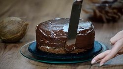 Chocolate ganache cake. Chef's hand spreading chocolate ganache glazed over torte. Stock Footage