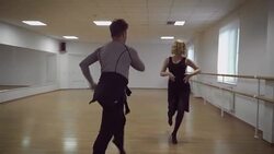 Man and a woman are dancing in the studio Stock Footage