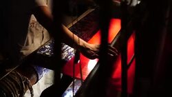 Craftsman working on huge old wooden brocade weaving looms Stock Footage