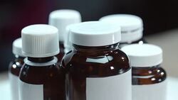 Medical bottles rotating on table. Pharmacy bottles. Pharmaceutical industry Stock Footage
