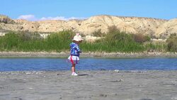 the child stands at the lake Stock Footage