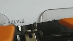 Close up footage of a person writing CHAPTER IV on an old typewriter, with sound... Stock Footage