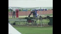 Athletes warm up jogging round track News Clip