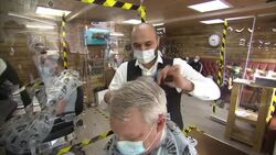 Men having haircuts in a barbers' after lockdown easing News Clip