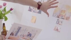 Creative designers discussing photograph proofs in office meeting Stock Footage