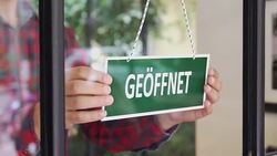 SLOW-MO: Young man opening a German shop Stock Footage