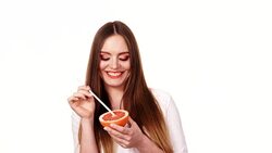 Woman holds grapefruit drinking juice from fruit 4K Stock Footage