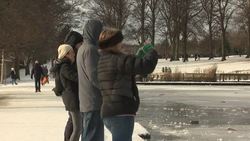 People ice skate on Edinburgh's frozen Inverleith Park pond News Clip