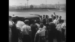 United States, c.1951: Joe DiMaggio is followed by fans as he enters a building and then stands next to the dugout Stock Footage
