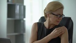 Business woman in eyeglasses feeling shoulder ache, muscle pain, overworking Stock Footage
