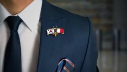 Businessman Walking Towards Camera With Friend Country Flags Pin South Korea - Malta Stock Footage