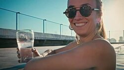 young sexy woman girls enjoying a drink in a luxurious flat water pool Stock Footage