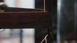 A wooden handle is sanded smooth in a blacksmithing workshop. Stock Footage