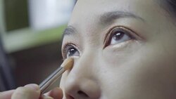 Professional make-up artist making up her model face Stock Footage