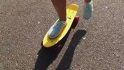 teenage girl feet riding short modern skateboard Stock Footage
