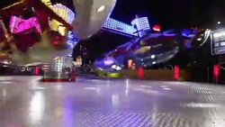 Colorful spinning wheel in amusement park at night Stock Footage