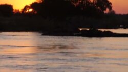 Travelling shot along Zambezi at sunset News Clip