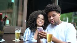 Happy young couple drinking beer in a bar - Portrait Stock Footage