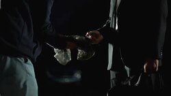 Illegal weapon trafficking, serial killer in suit paying for handgun at parking Stock Footage